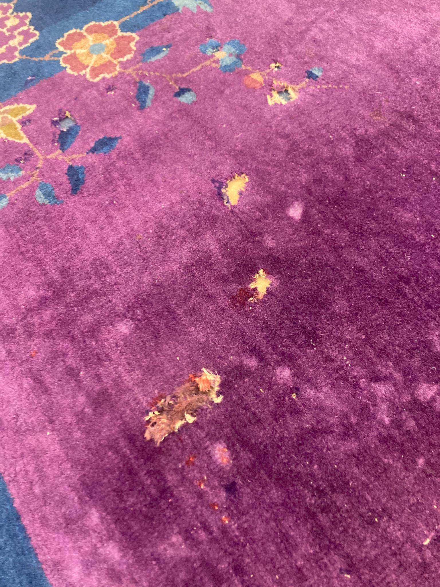 A large purple ground Chinese wool carpet, 342 x 276cm